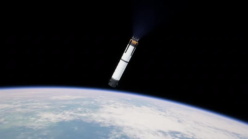 La primera etapa ya usada, separándose sobre la curva de la Tierra, con los motores brillando débilmente contra el negro del espacio